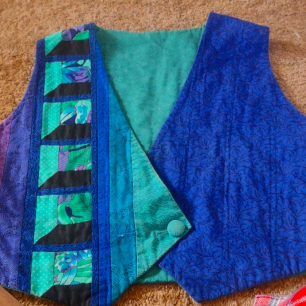2 Quilted vests both fit like a medium. 1st one is black, blue, purple and green